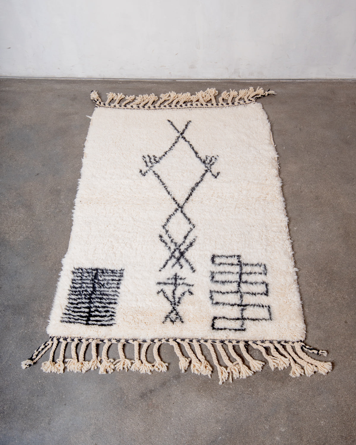 Modern, designer, handcrafted Berber rug from Morocco. Beniourain carpet with minimalist design, natural wool pile and a fluffy texture.